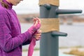 Girl wrapping a wrist wrap around her hand before outdoor martial arts training Royalty Free Stock Photo