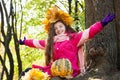 Girl in a wreath of maple leaves in park