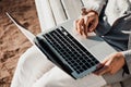 Girl writer sits on a park bench and works on a laptop