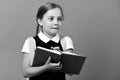 Girl writes in big blue notebook. Pupil in school uniform Royalty Free Stock Photo