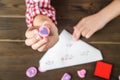 The girl writes a love letter for Valentine`s Day. The girl writes a letter of thanks to mom and dad. Stamps and a letter on a tex Royalty Free Stock Photo