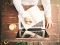 Girl writes in a notebook on a wooden desk with a cup of coffee Royalty Free Stock Photo