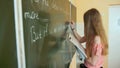 A girl writes on a school board during an English lesson. Royalty Free Stock Photo