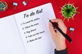 A girl writes a to-do list on red desk. Check list Royalty Free Stock Photo