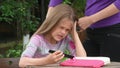 Girl writhing in pain while my mother combing her long tangled hair