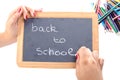 A girl writing back to school on blackboard Royalty Free Stock Photo