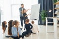 Girl writing on the board. Group of children students in class at school with teacher Royalty Free Stock Photo