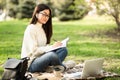 Girl writing in diary, sitting in parkland Royalty Free Stock Photo