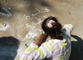 Girl writing graffiti with white chalk on the ground in a camping trip in Egypt