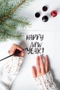 Girl writing Happy new year calligraphy card Royalty Free Stock Photo