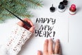 Girl writing Happy new year calligraphy card Royalty Free Stock Photo