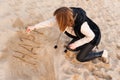 Girl Writing New Year in Sand Royalty Free Stock Photo