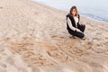 Girl Writing New Year in Sand Royalty Free Stock Photo