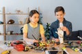 girl writing in notebook while boy