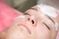 Girl's face during a cosmetic procedure. Cleansing the skin of the face from comedones.