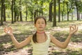 girl& x27;s happy and Meditate on the practice of yoga in the park , yoga kid. Healthy lifestyle - little girl doing yoga in the