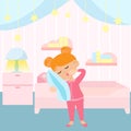 The girl yawns. A child is standing with a pillow in a children\'s bedroom.