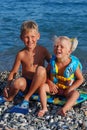 The girl of 3 years, the blonde, and her elder brother on a sea