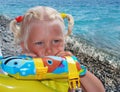 The girl of 3 years, the blonde, on a sea beach