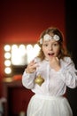 Girl of 8-9 years with delight admires gold Christmas-tree decorations. Royalty Free Stock Photo