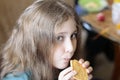 Girl 10 years old eating cookies. Bright expressive look, portrait in soft focus blur background.