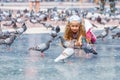 A girl 6-7 years old, feeding pigeons at Plaza de Catalunya in Barcelona. Royalty Free Stock Photo