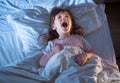 Girl 4 years old screaming while lying in bed