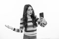 Girl 12, 13, 14 years old with smart phone. Hipster teen girl types message on cellphone, enjoys mobile app. Surprised Royalty Free Stock Photo