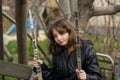 Girl 10 years old swinging on a swing in the spring.