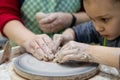 Girl 6 years old works on a pottery wheel, close-up of  girl`s and teacher`s hands. Royalty Free Stock Photo