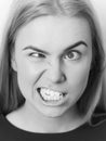 Girl is yelling at the camera. Woman squinting eyes on silly face Royalty Free Stock Photo