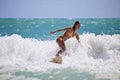 Girl in a yellow bikini surfing Royalty Free Stock Photo