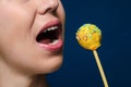 Girl with yellow cakepop Royalty Free Stock Photo