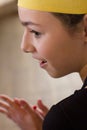 Girl in the yellow chef`s cap and black apron gaily looks to the Royalty Free Stock Photo