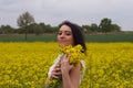 A girl in a yellow flower field, a beautiful spring landscape, a bright sunny day, canola.