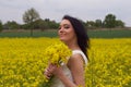 A girl in a yellow flower field, a beautiful spring landscape, a bright sunny day, canola.