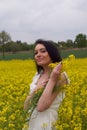 A girl in a yellow flower field, a beautiful spring landscape, a bright sunny day, canola.