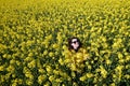 Girl and yellow flowers of rapeseed. Oilseed plant. Travel outside the city. Summer sunny weather Royalty Free Stock Photo