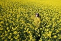 Girl and yellow flowers of rapeseed. Oilseed plant. Travel outside the city. Summer sunny weather Royalty Free Stock Photo