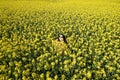 girl and yellow flowers of rapeseed. oilseed plant. travel outside the city. summer sunny weather Royalty Free Stock Photo