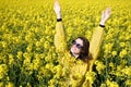 Girl and yellow flowers of rapeseed. Oilseed plant. Travel outside the city. Summer sunny weather Royalty Free Stock Photo