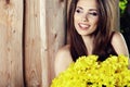 Girl with yellow flowers smiling