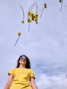 Girl and yellow flowers. Travel outside the city. Wildlife. Summer time Royalty Free Stock Photo