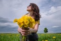 Girl and yellow flowers. Travel outside the city. Wildlife. Summer time Royalty Free Stock Photo