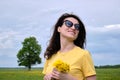 Girl and yellow flowers. Travel outside the city. Wildlife. Summer time Royalty Free Stock Photo