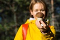 Girl in a yellow jacket with a backpack and a basket holds in he Royalty Free Stock Photo