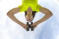 Girl in a yellow jacket looking through binoculars against the sky Royalty Free Stock Photo