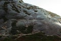 A girl in a yellow raincoat goes down the stone steps in the mountain of norway Royalty Free Stock Photo