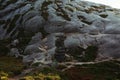 A girl in a yellow raincoat goes down the stone steps in the mountain of norway Royalty Free Stock Photo