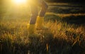 A girl in a yellow rubber boots walks through the forest. Travel concept with children. Autumn in the forest. Royalty Free Stock Photo